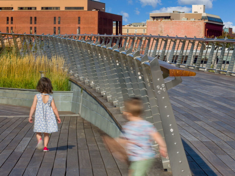 The Michael S. Van Leesten Memorial Bridge: A wooden walkway elevated by a metal railing.