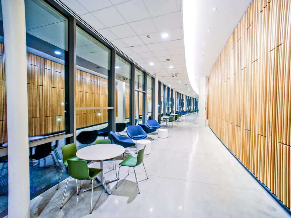 An Integrated Science Commons featuring a hallway adorned with wooden slats and chairs.
