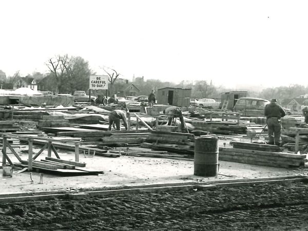 A black and white photo capturing our history of people working on a construction site.