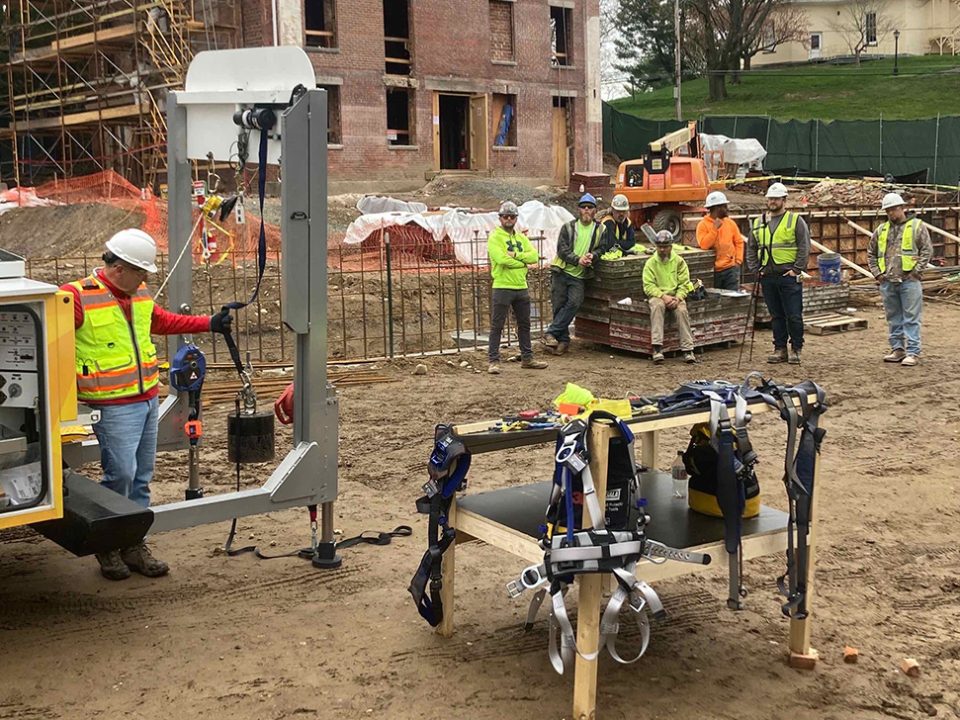 A group of construction workers diligently ensuring safety at a construction site.