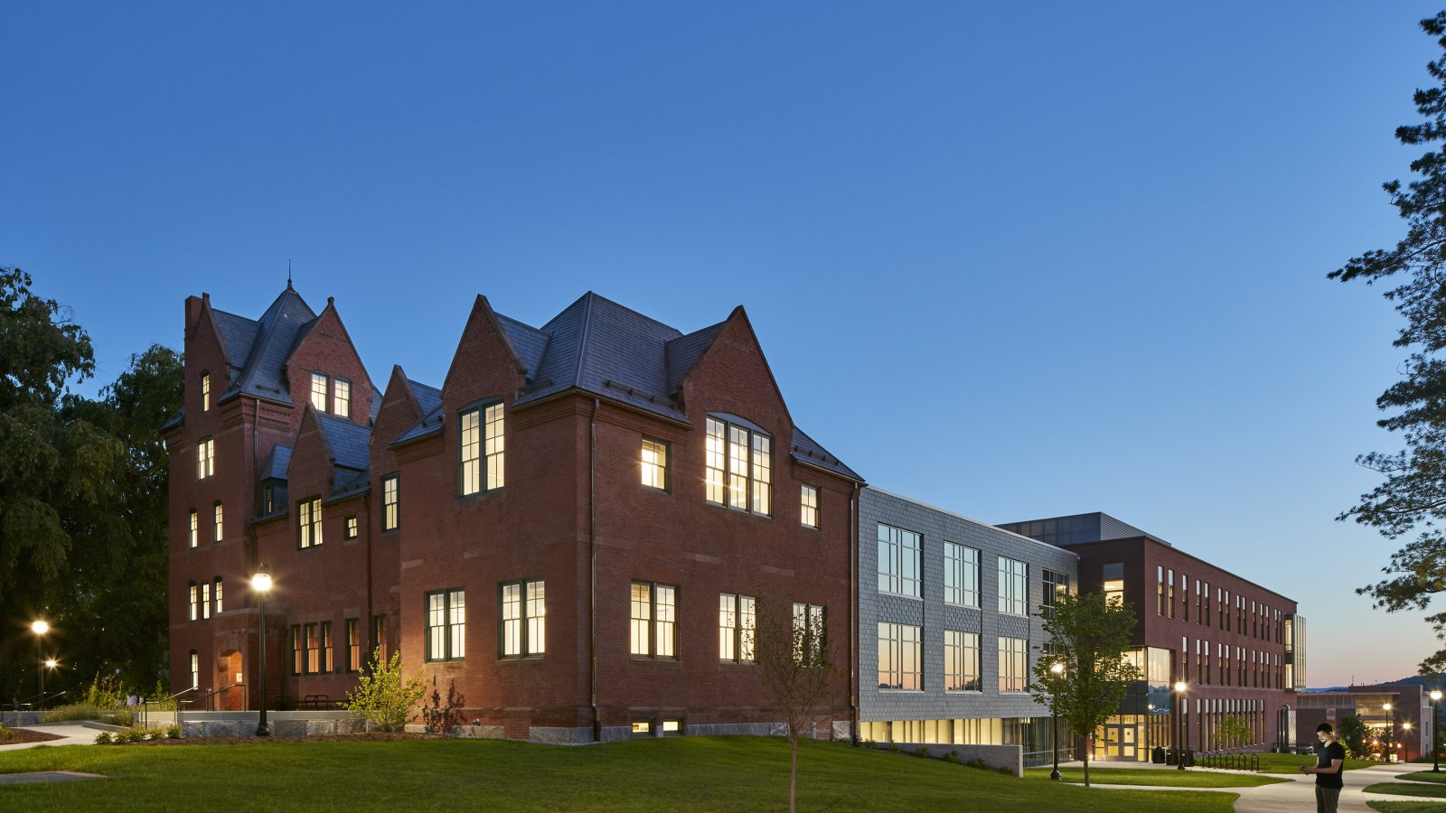 A large red brick South College Academic Facility at dusk in University of Massachusetts–Amherst.